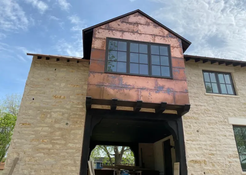 Copper metal panel facade on a stone building for Skylight Installation in Buckhead