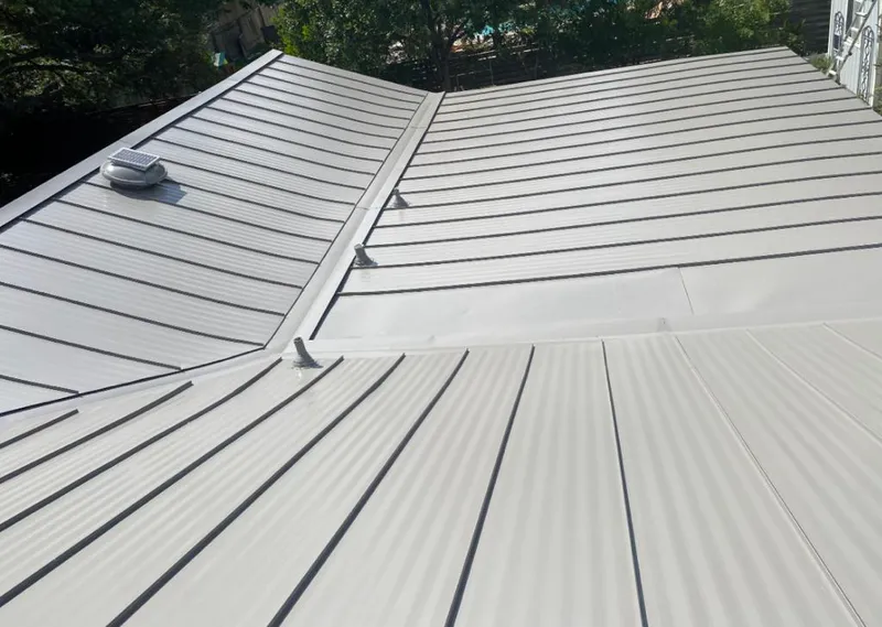 Solar attic fan installed on a metal roof for Roof Ventilation in Buckhead
